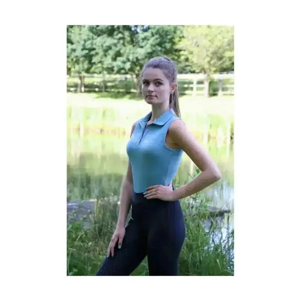 A light blue hy equestrian synergy sleeveless polo with collar and fitted silhouette showing sleeveless polo features