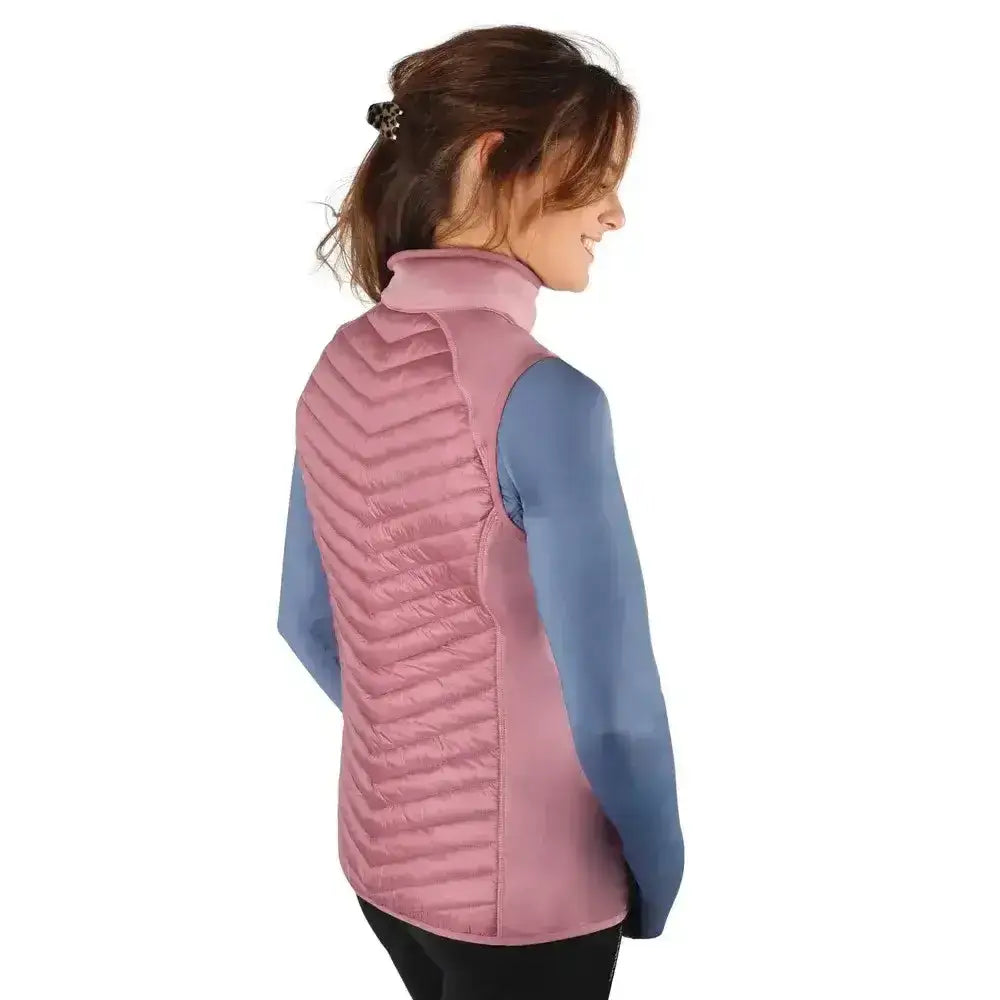A soft pink quilted puffer vest with high collar and chevron stitching from hy equestrian synergy sync lightweight padded gilet