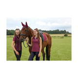 The horse wears a maroon ear cover and saddle pad matching the hy equestrian synergy t-shirt fig design
