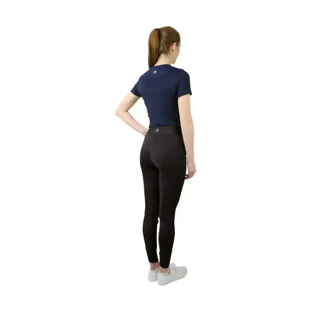 Back view of navy equestrian synergy t-shirt with small logo paired with black leggings for active wear