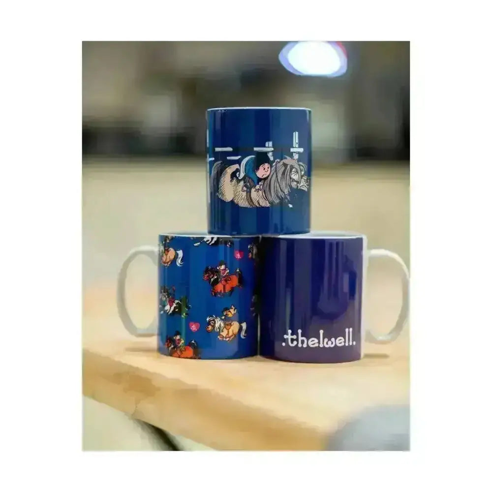 Blue ceramic mugs with white handles featuring classic thelwell character from the equestrian thelwell collection