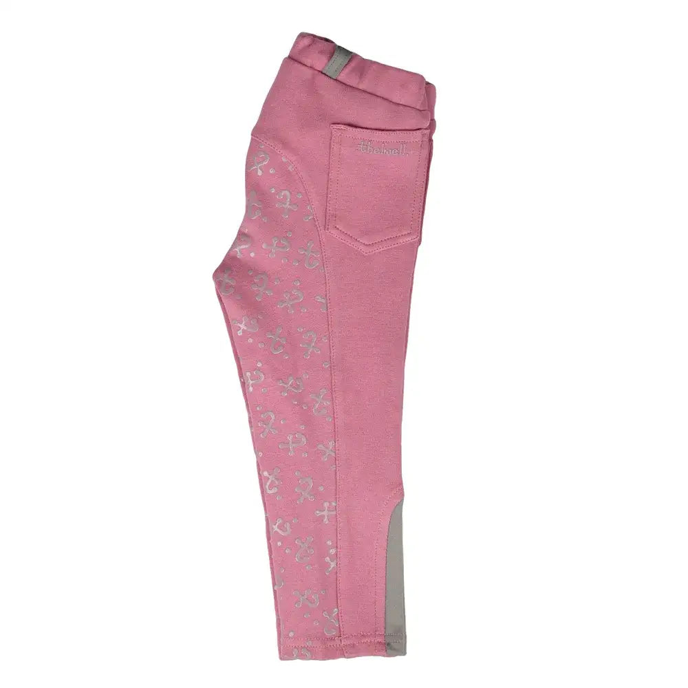 Pink thelwell mini tots jodhpurs with silver horse print and gray reinforced panels perfect for silicone equestrian use