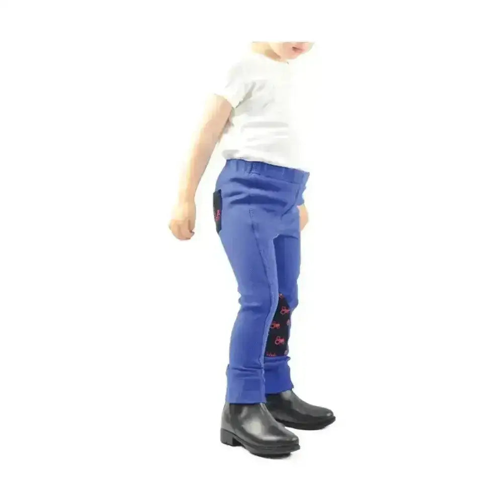 Blue children’s rock tots jodhpurs with black knee patches and pink lettering from hy equestrian tractors rock line