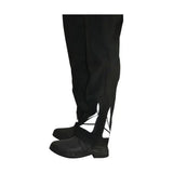 Black over-the-knee boots with white lace-up detailing paired with equestrian waterproof reflective trousers fit neatly