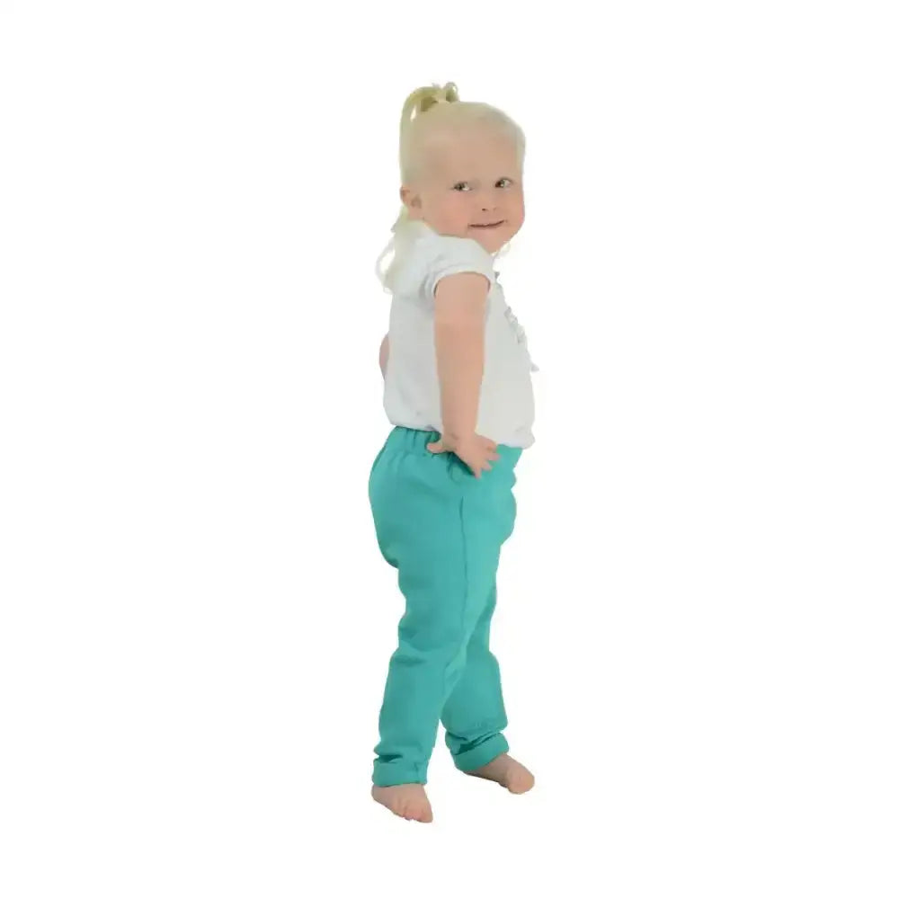 A toddler wearing teal equestrian zeddy tots pull-on tots jodhpur pants with relaxed fit and elastic waistband