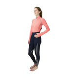 A woman wearing a coral hy sport active base layer top with soft breathable fabric and navy close fit base leggings