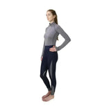 A woman wearing hy sport active base layer with gray soft breathable fabric top and close fit navy leggings with gray panels