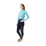 A woman wearing a light blue hy sport active base layer with soft breathable fabric and dark navy mesh leggings