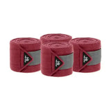 Set of four maroon felt active luxury bandages with gray elastic bands and black branding labels for sport use