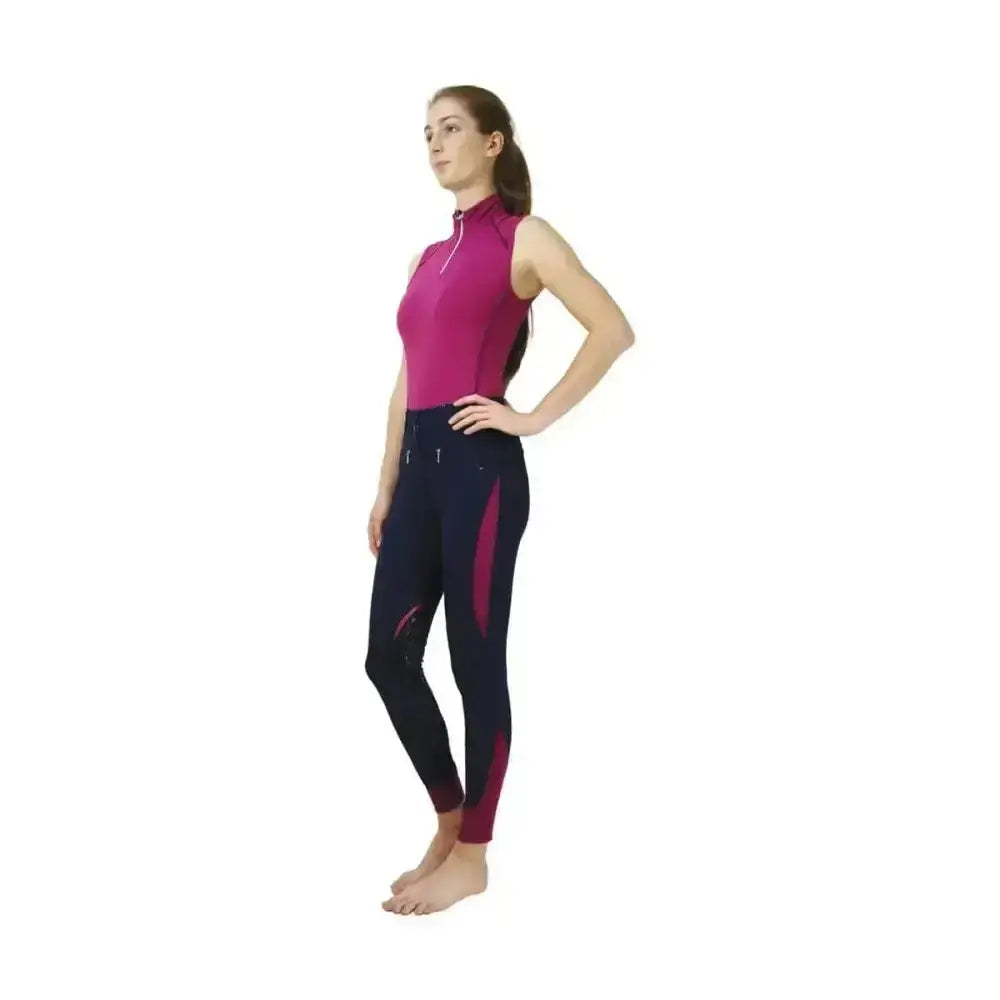 Fuchsia and navy blue equestrian riding pants with a zippered high neck hy sport active sleeveless top from sport active collection base layers