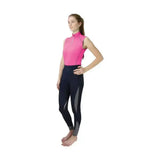 A woman wearing a vibrant pink hy sport active sleeveless zip-up top from the sport active collection with navy leggings