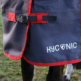 Navy blue and red hyconic 0g turnout rug with white branding super lightweight turnout perfect for active horses