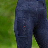 Dark blue hyconic valloria denim riding tights with subtle texture and vertical logo on side pocket