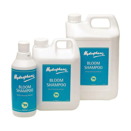 White plastic bottles of hydrophane bloom shampoo in various sizes with blue labels and a green horse logo for coat fresh use