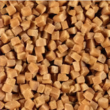 Brown cube-shaped plastic pellets used as ice cream toppings for creamy dessert decoration and texture