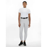 Woman wearing imogen knee grip breeches light grey with a white high neck short sleeve top and black belt