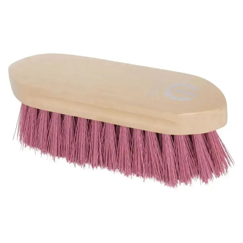 A pink imperial riding dandy brush hard with wooden back and light wood handle for grooming horses