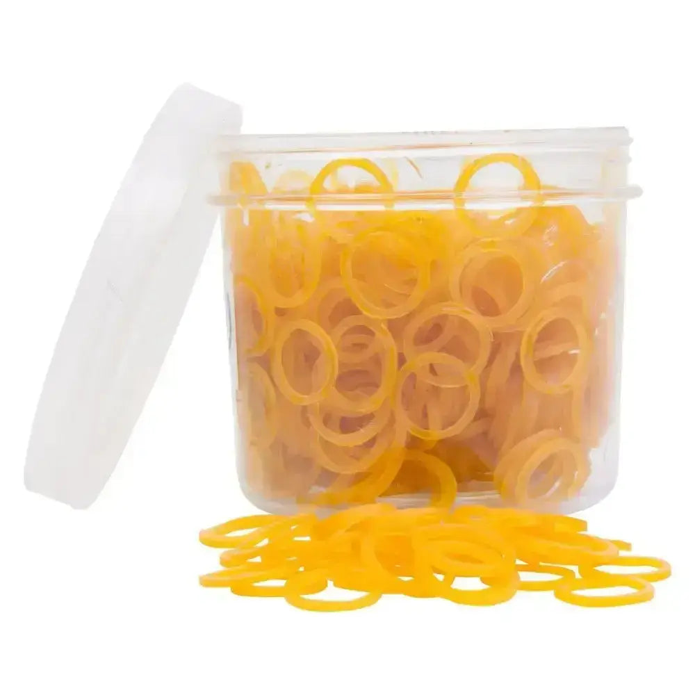 A clear plastic container of bright yellow imperial riding plaiting natural rubber bands with some spilling out