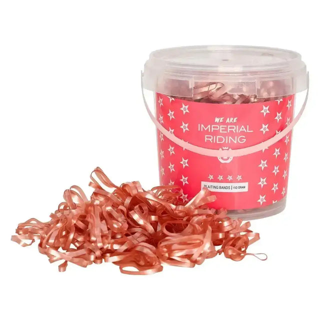 A container of imperial riding plaiting bands profi-box rose gold with shiny metallic strips and a pink star label spilling out