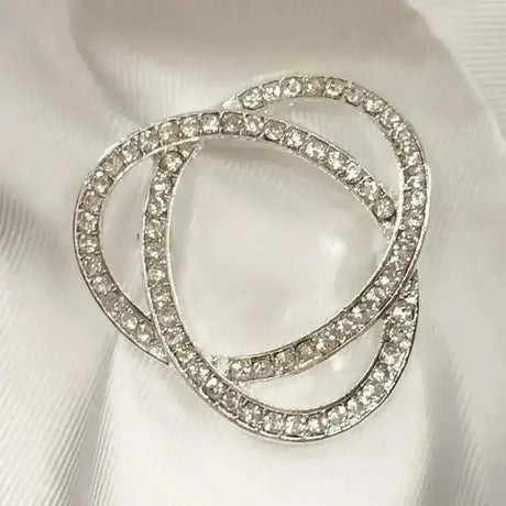 Silver rhinestone infinity stock pin with three interlocking circular bands and stunning diamante detail