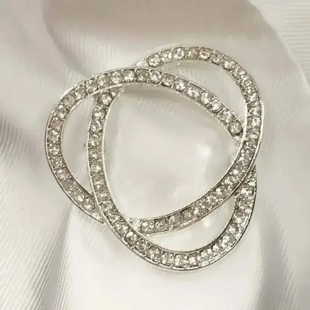 Silver rhinestone infinity stock pin with three interlocking circular bands and stunning diamante detail