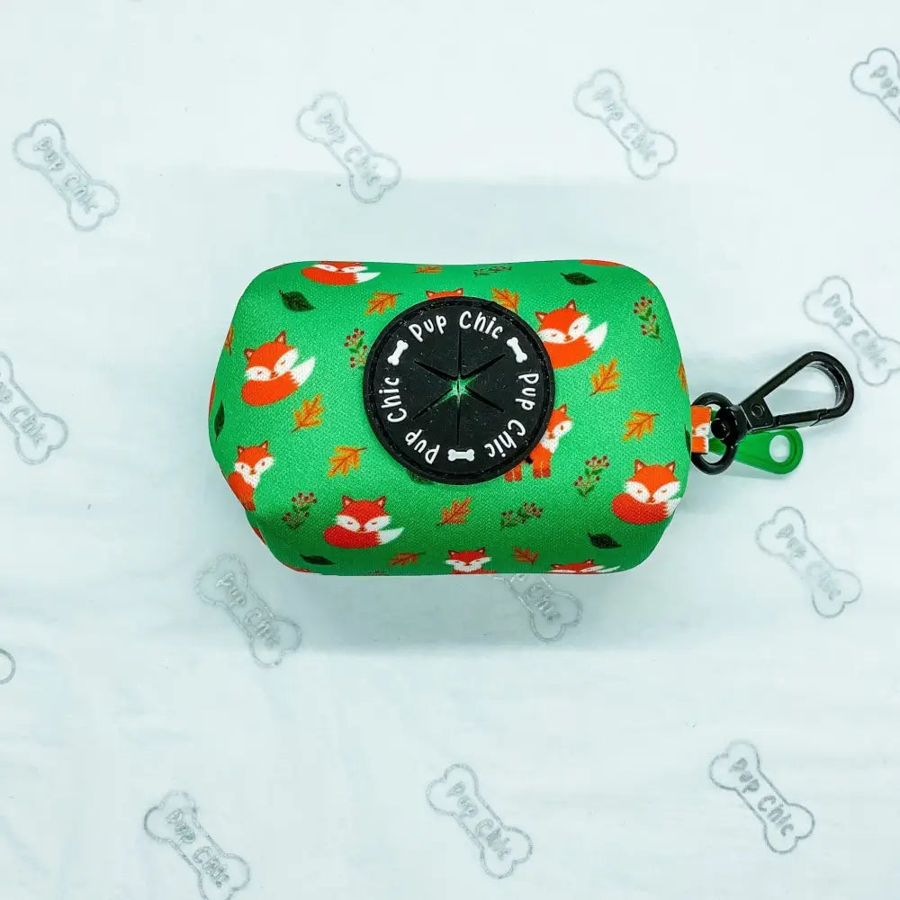 Green fabric inquisitive fox poo bag holder with playful fox pattern black pup chic top and green carabiner clip