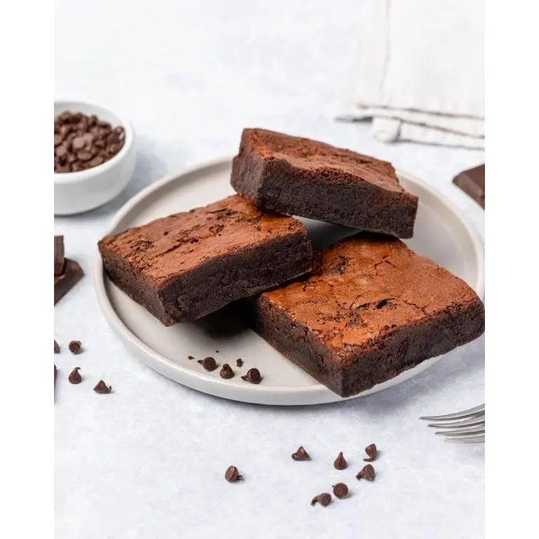 Jessica’s cakes chocolate brownie gf rich handmade cake with fudgy texture and chocolate chips on plate