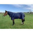 Navy blue jhl essential medium weight 200g combo turnout rug with red trim and logo on the side