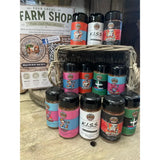 A collection of colorful jim slim barbecue seasonings in cylindrical jars with black caps and fun cartoon labels