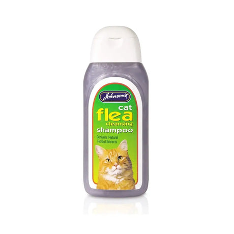 Johnson’s veterinary cat flea cleansing shampoo in a translucent purple bottle with green label and orange tabby image