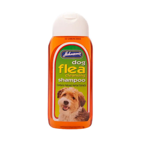 Johnson’s veterinary dog flea cleansing shampoo in a translucent orange bottle with a white cap and puppy label