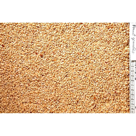 A textured fabric with dense beige and tan fragments resembling crushed peanuts from johnston & jeff peanut granules