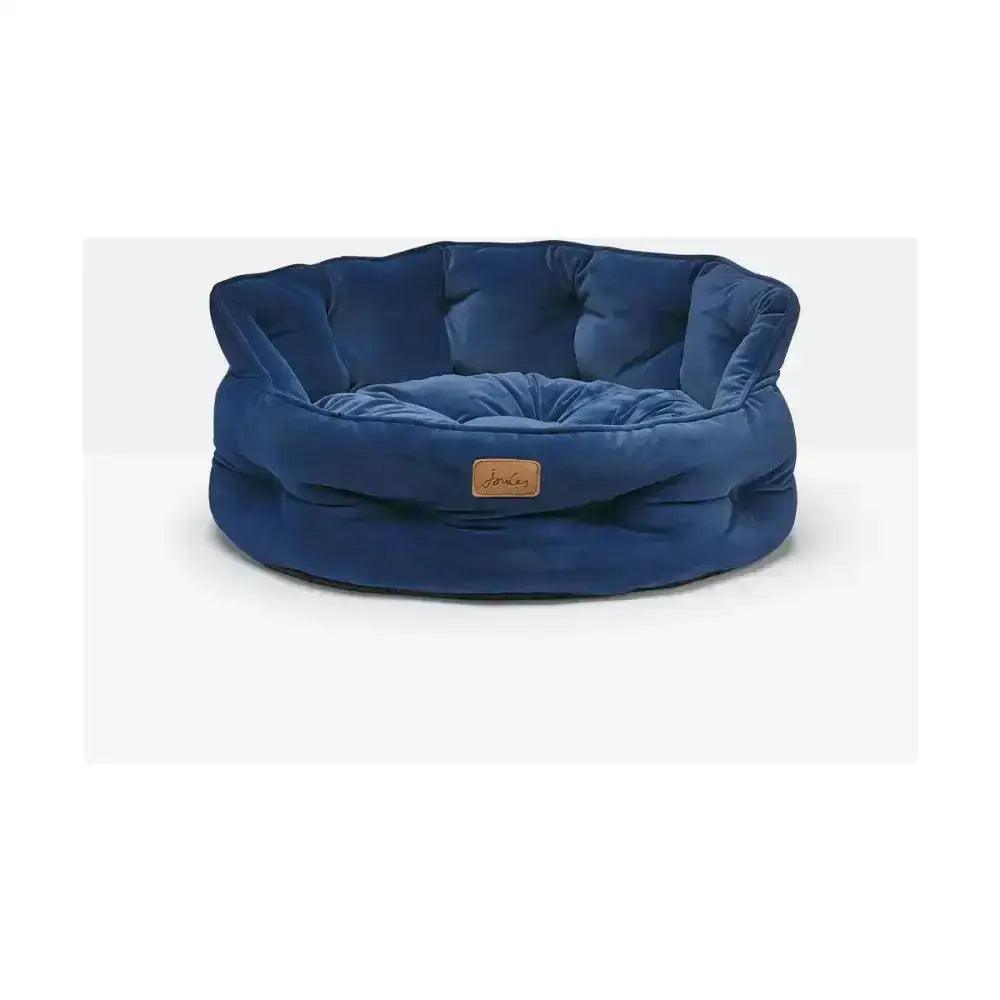 Deep blue velvet joules chesterfield pet bed with plush cushioned design and small leather brand tag for sleeping dogs lie