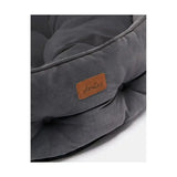 A plush dark grey joules chesterfield pet bed with soft suede texture and tan leather brand patch for sleeping dogs lie
