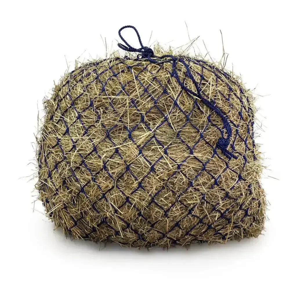 A round beige hay bale in a dark blue mesh net with tied handles from the elite deluxe haynet extra strong jumbo range