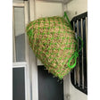 Green mesh km elite travel pony haynet filled with golden straw hanging inside vehicle deluxe travel haynet