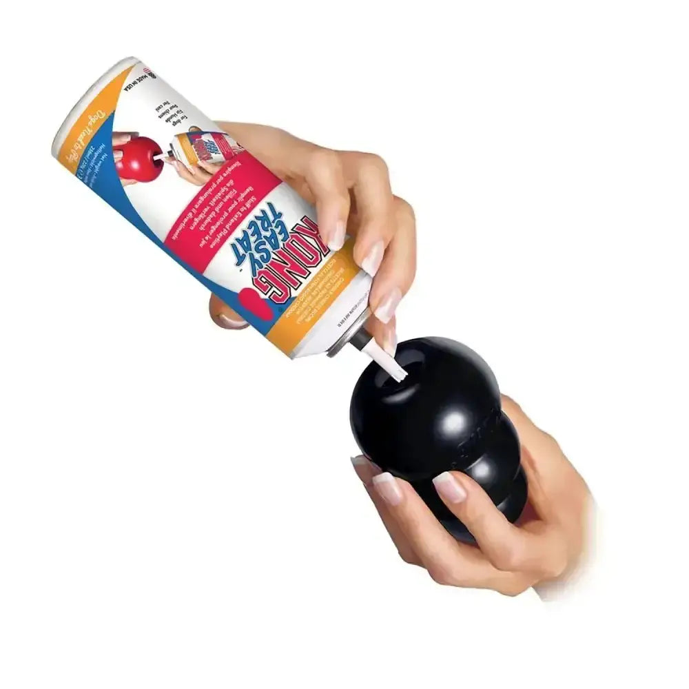 Black kong extreme durable dog toy being filled with spray can as a tough original kong toy for fresh play
