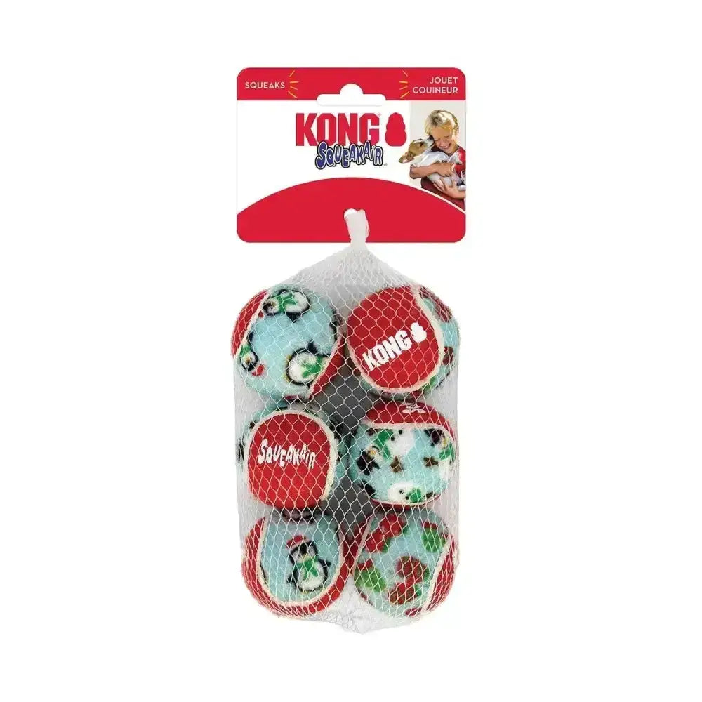 A festive red and teal kong holiday squeakair ball set with holiday designs featuring penguins and snowflakes