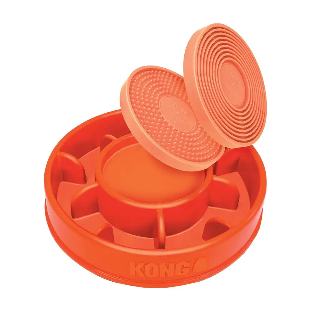 Bright orange kong licks mealtime lick pad pet feeder with textured slow feeder design and multiple compartments