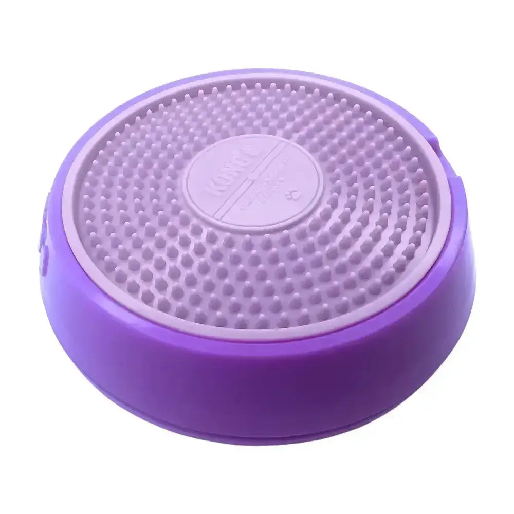 Purple circular kong licks spinz pet feeding dish with textured raised dots and central embossed logo