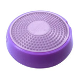 Purple circular kong licks spinz pet feeding dish with textured raised dots and central embossed logo