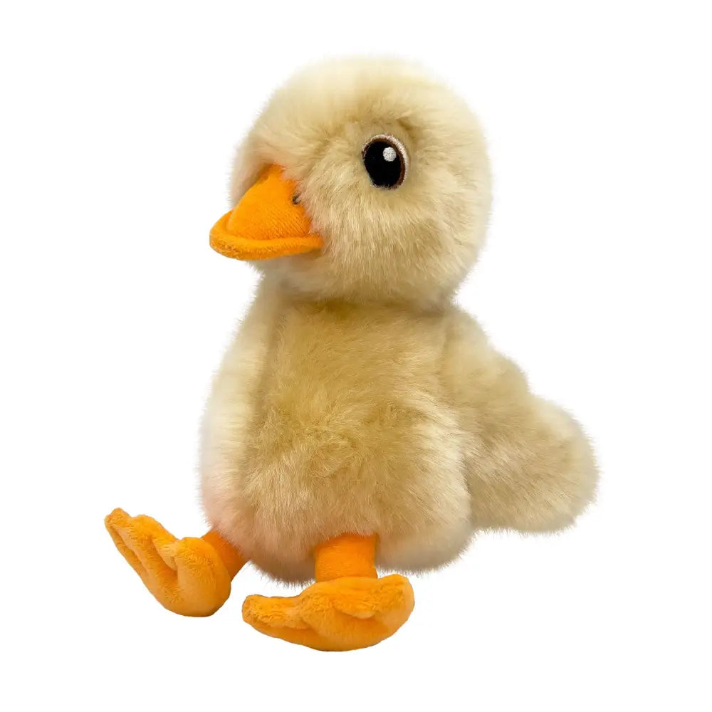 Cute cream-colored plush kong toughz duck with bright orange beak and feet and soft fluffy texture