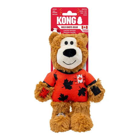 A plush brown bear in an orange sweater with maple leaf patterns packaged in a red kong wild knots sport card