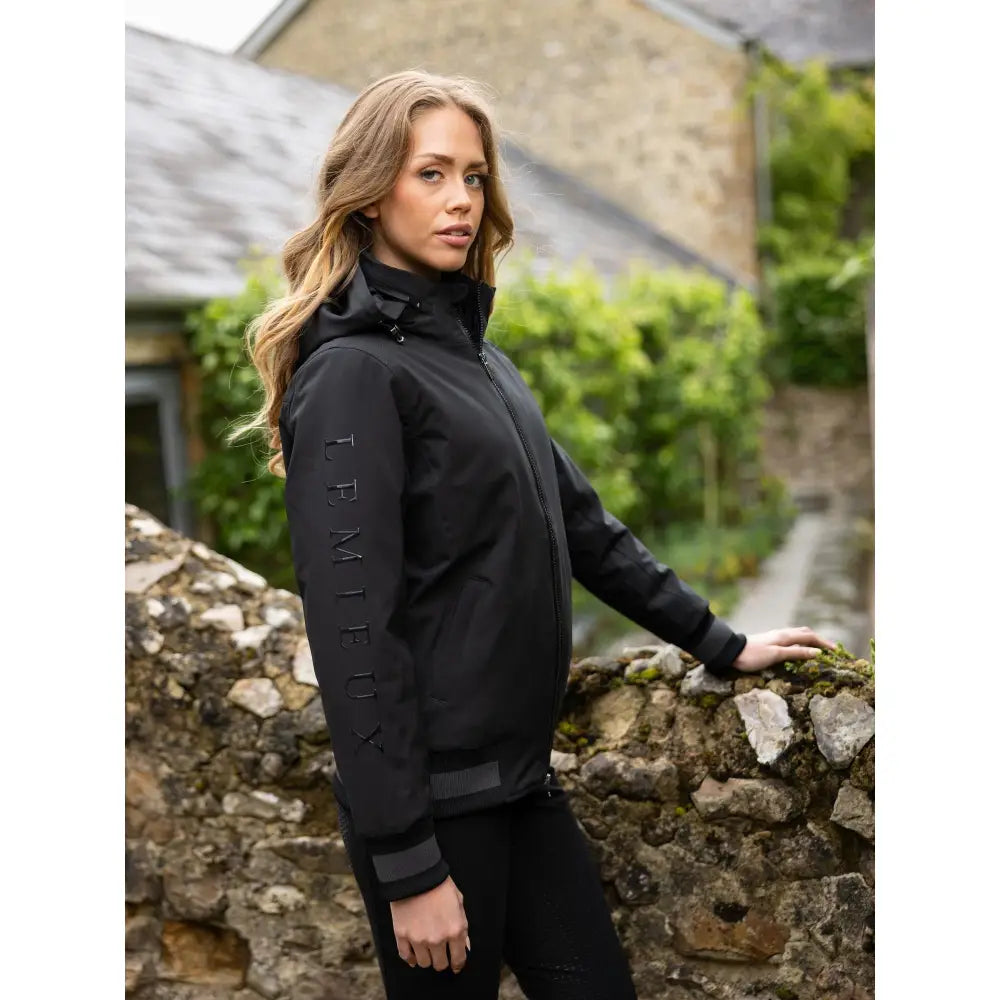Black waterproof ladies team jacket with subtle trmieux branding on the sleeve perfect for teams