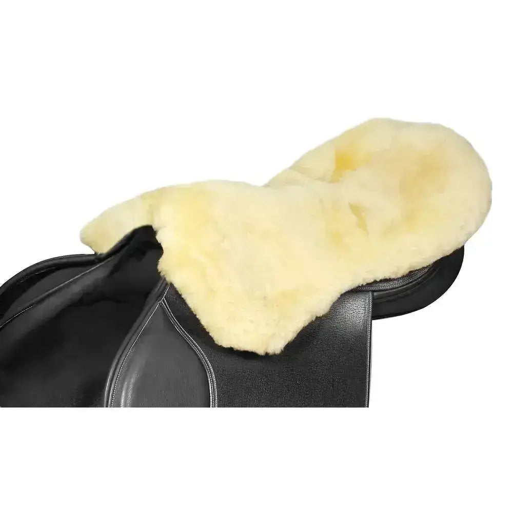 Cream-colored lambswool seat saver with soft fluffy sheepskin texture fits securely on black leather saddle with streamlined shaping