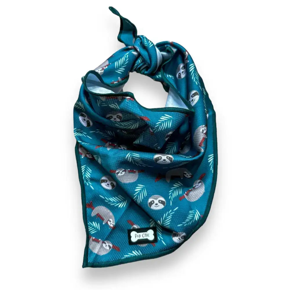 Teal lazy sloth cooling bandana with playful sloth and leaf pattern and pup chic brand tag for hot days