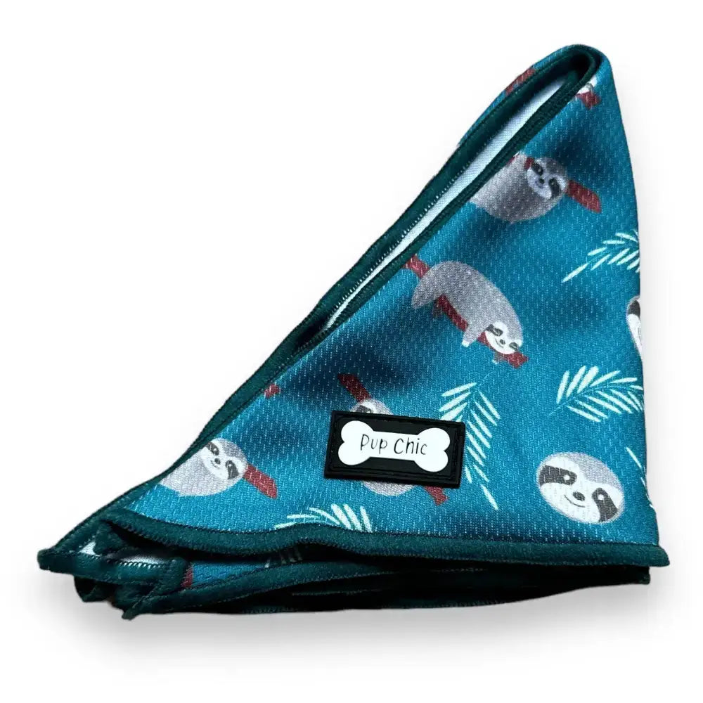 Teal lazy sloth cooling bandana with playful sloth and palm leaf pattern black trim and pup chic bone label
