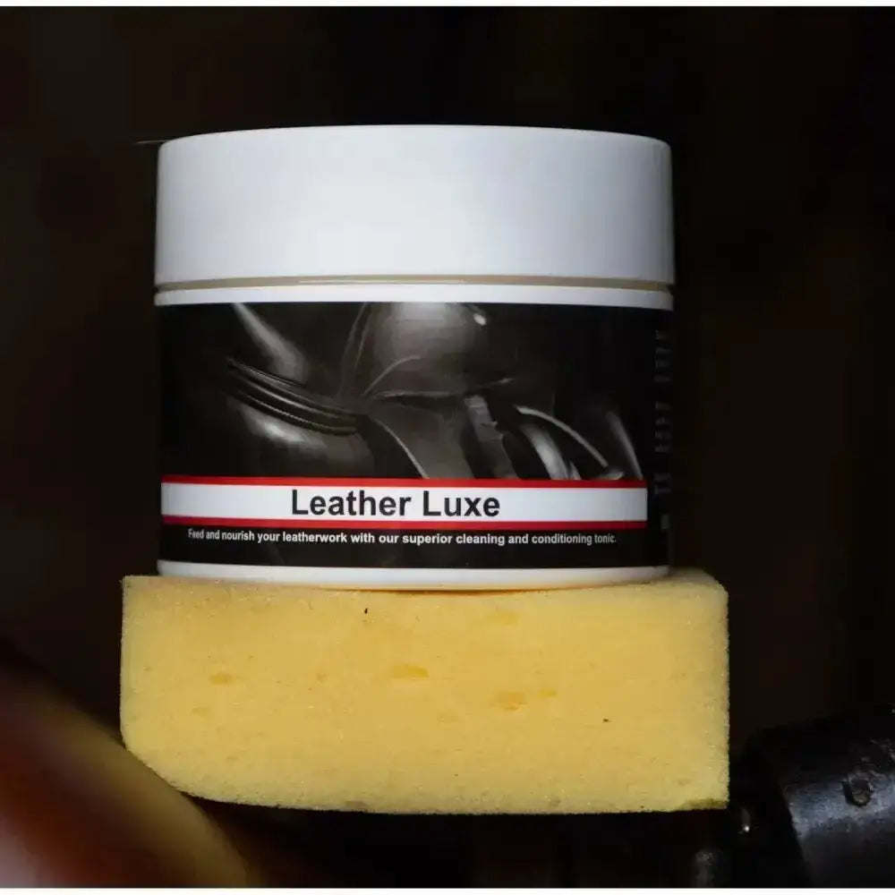 White cylindrical container of leather luxe 200g leather cleaning and conditioning tonic with black label and red trim