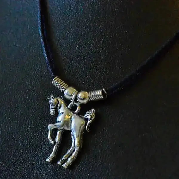 Silver prancing pony pendant approx 3cm on black leather necklace with metallic beads for casual wear