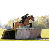 A chestnut horse leaps over an obstacle wearing lemieux 3d mesh eurojump square black with maximum airflow